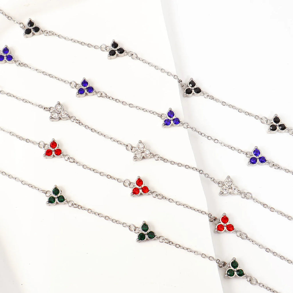 Women's geometric stainless steel bracelet with triple diamond design and coloured stone in gold or steel tone.