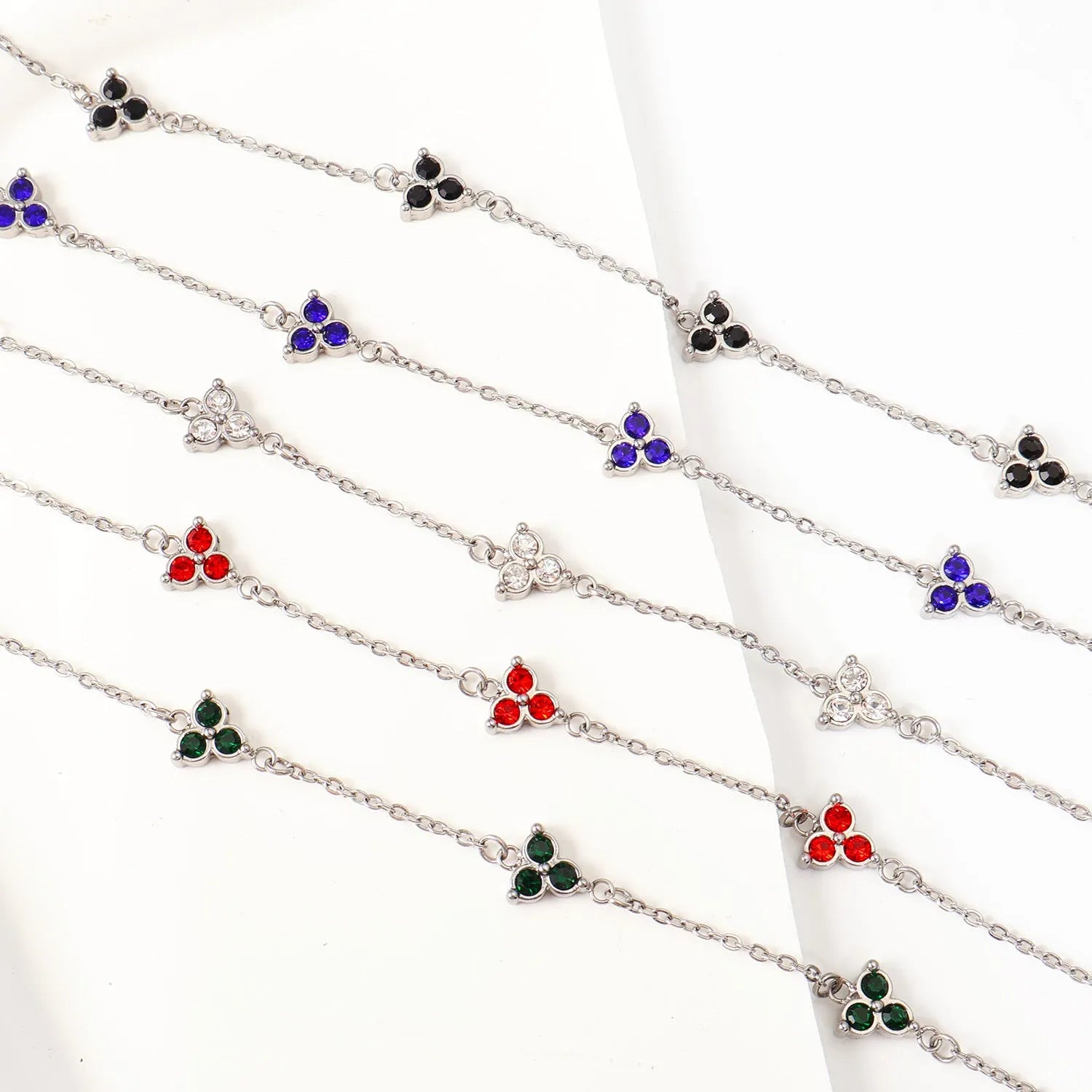 Women's geometric stainless steel bracelet with triple diamond design and coloured stone in gold or steel tone.