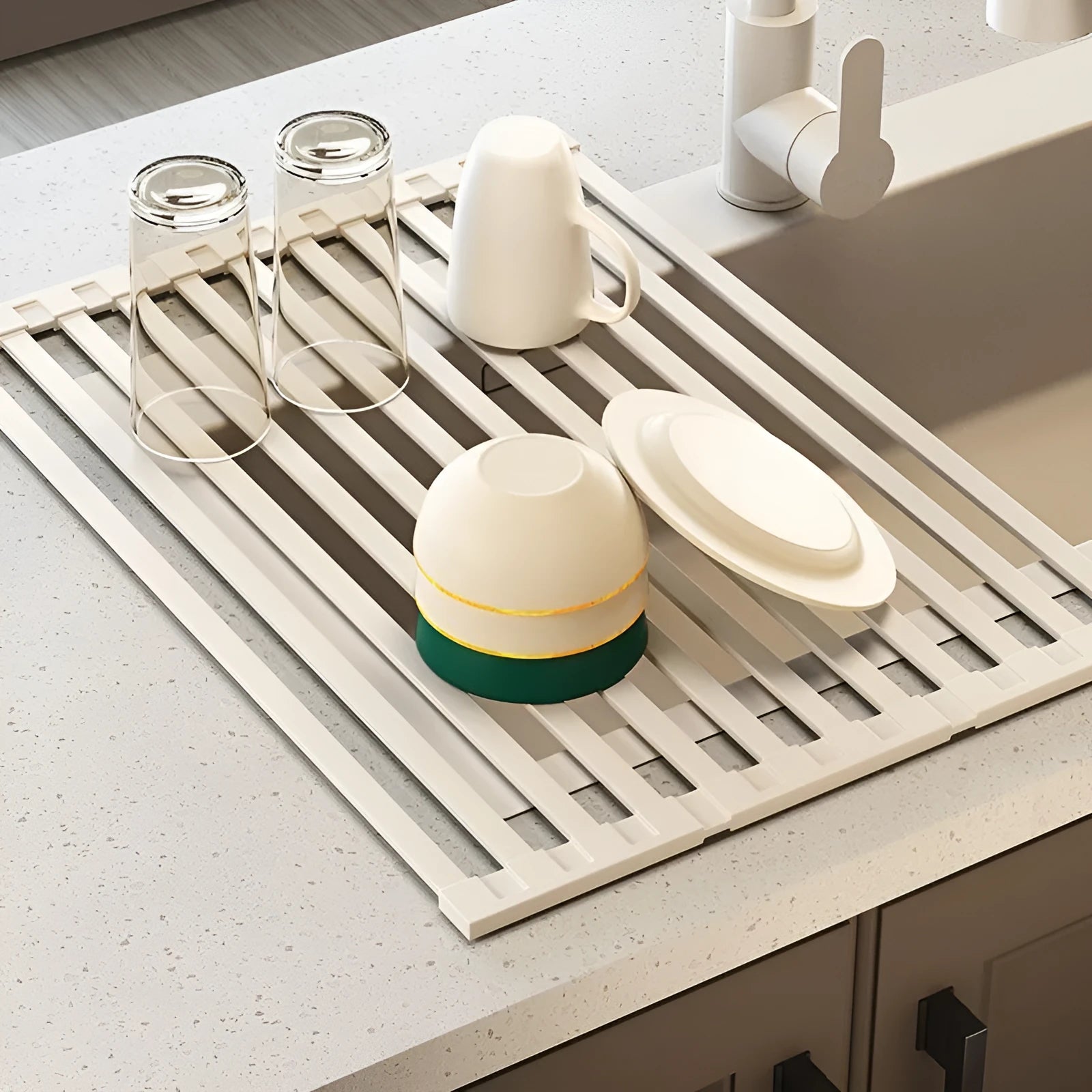 Foldable milky white stainless steel kitchen draining rack shown extended over a sink.