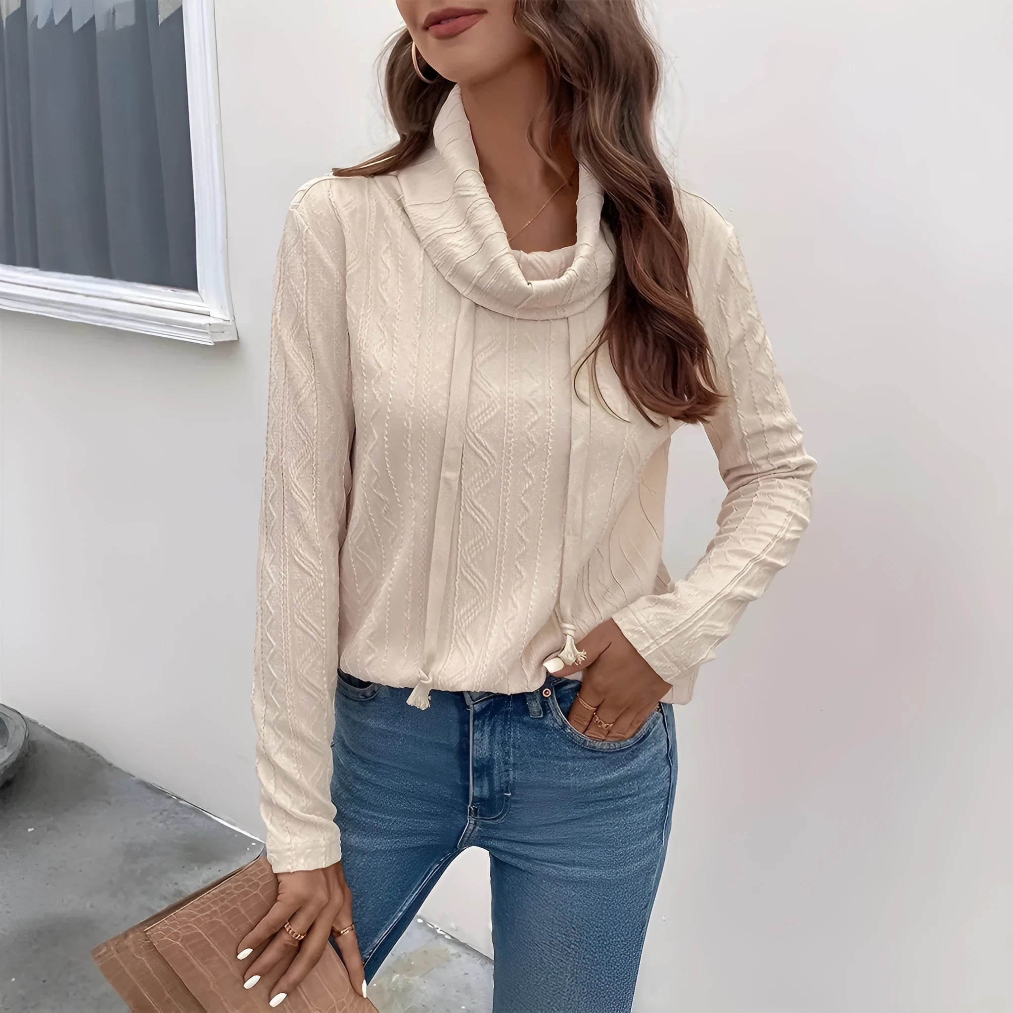 Apricot coloured hooded pullover sweater with long sleeves and a drawstring on the hood.