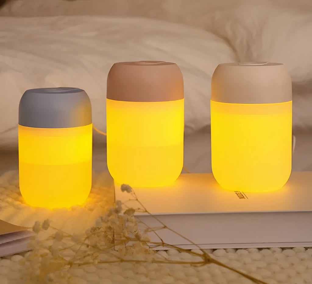 White cylindrical mini USB humidifier with aromatherapy function on wooden desk