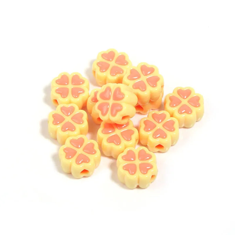 Assorted light-coloured acrylic clover-shaped beads with frosted finish, 15mm size.