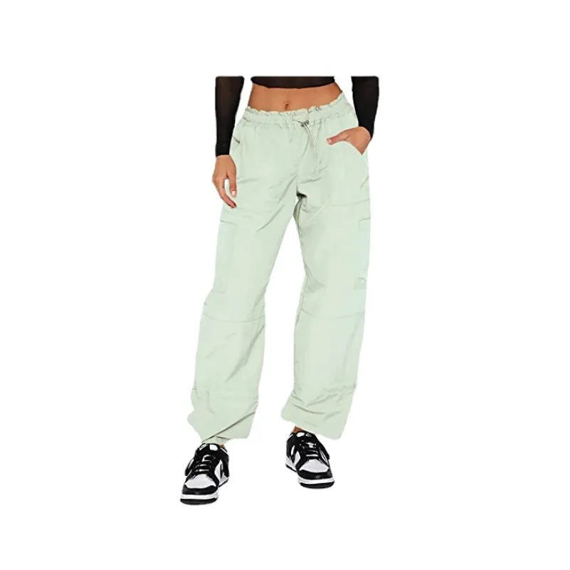 Loose-fit straight-leg cargo casual trousers in grey on a model, showing multiple pockets and mid-rise waist.
