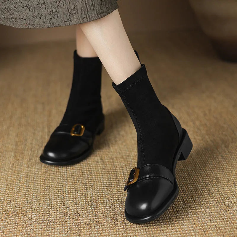 Women's black casual Martin-style ankle boots with buckle stitching and front lace-up on a low rubber sole.