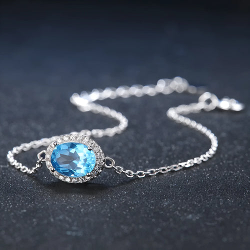 925 sterling silver jewellery set with blue topaz gemstones showing geometric design earrings, ring, pendant, and necklace