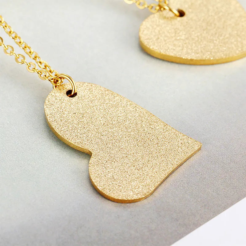 Geometric heart-shaped titanium steel pendant necklace on a chain, silver tone KN25736-Z.