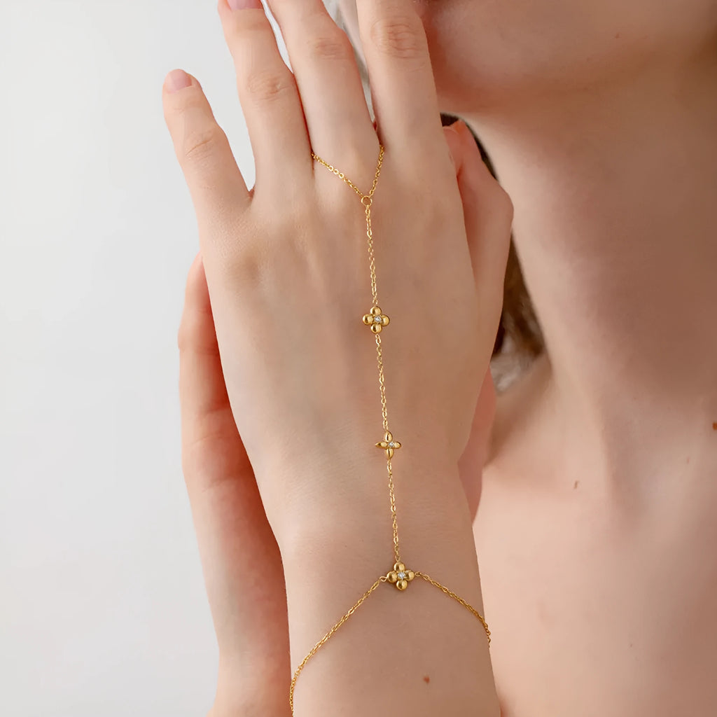 Gold tone women's bracelet with geometric floral and eight-pointed star design in stainless steel
