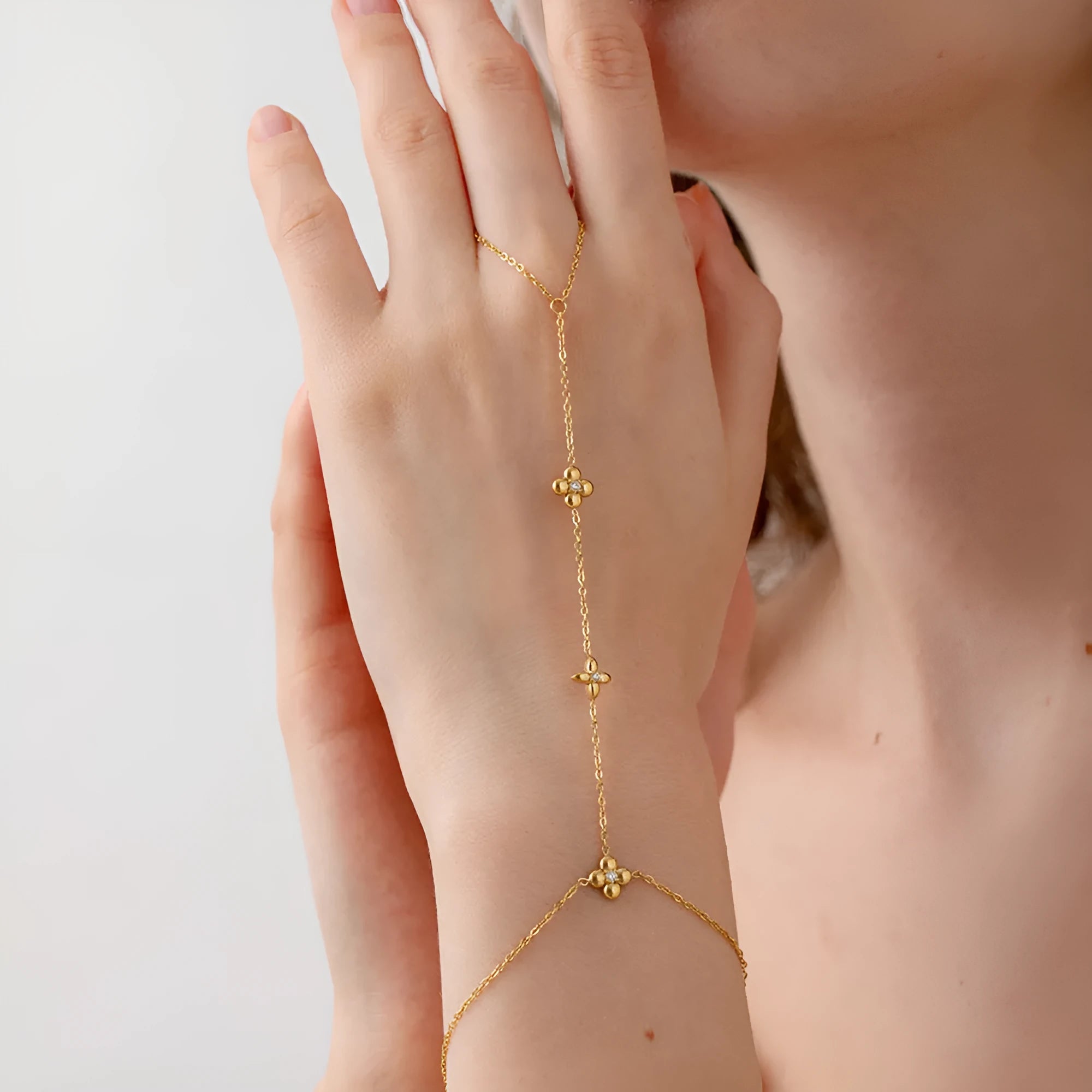 Gold tone women's bracelet with geometric floral and eight-pointed star design in stainless steel