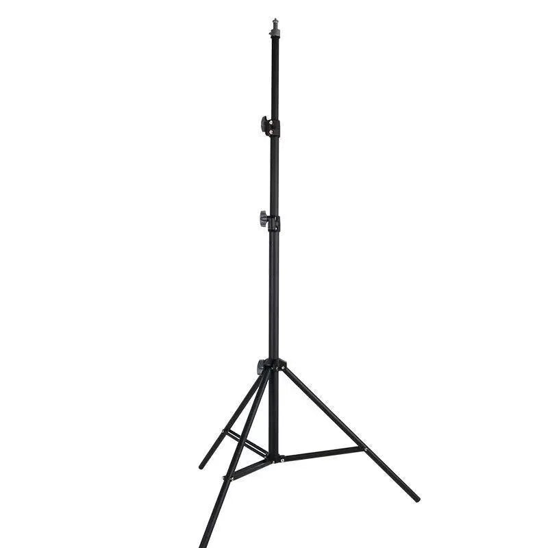 A frosted finish floor tripod light stand at full height with a mobile phone holder attached.