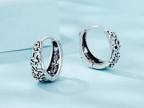 Close-up of women's retro hollow butterfly earrings made from S925 sterling silver with zircon stones.