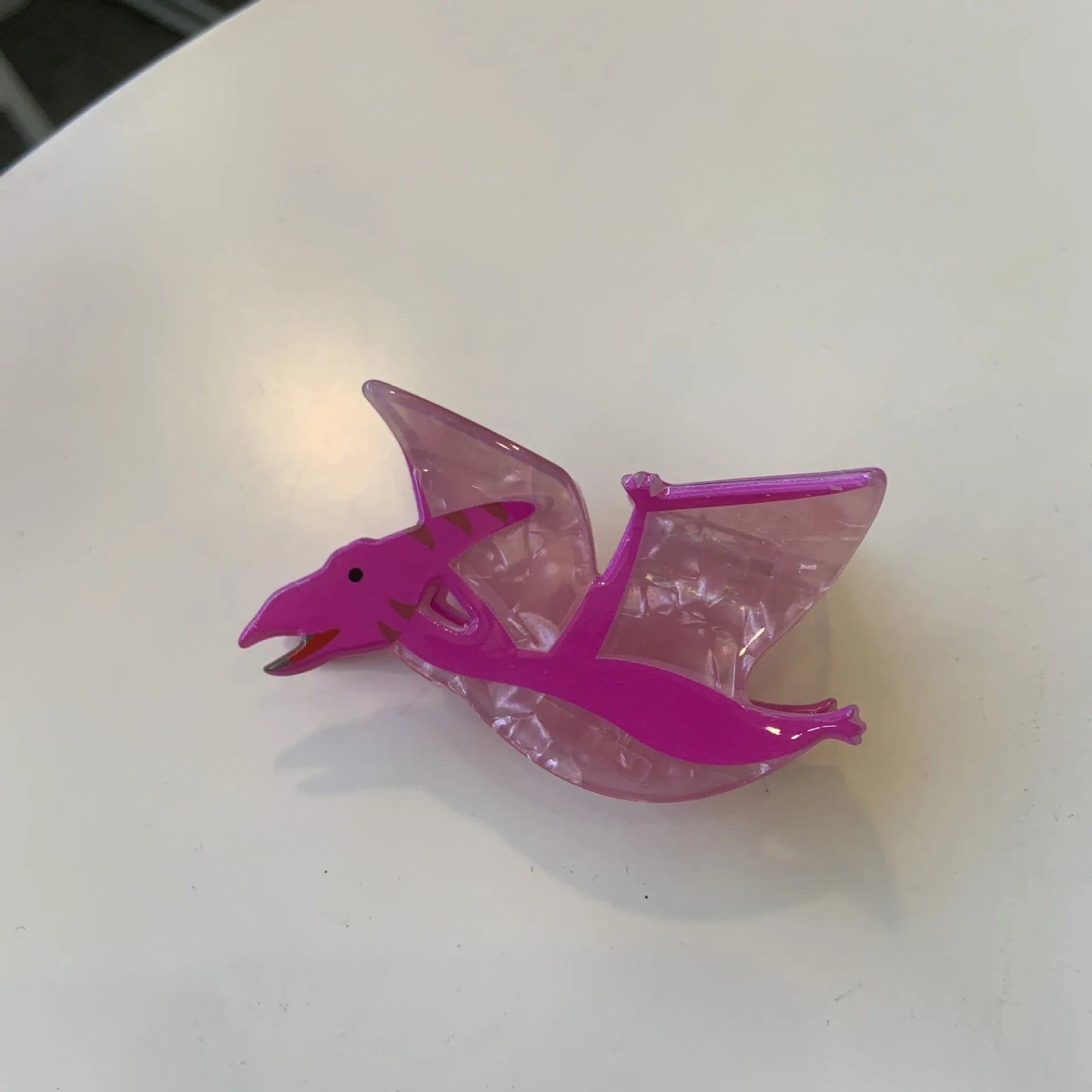 Dinosaur acrylic jaw hair clip showing grip mechanism and detailed dinosaur design in available colour options