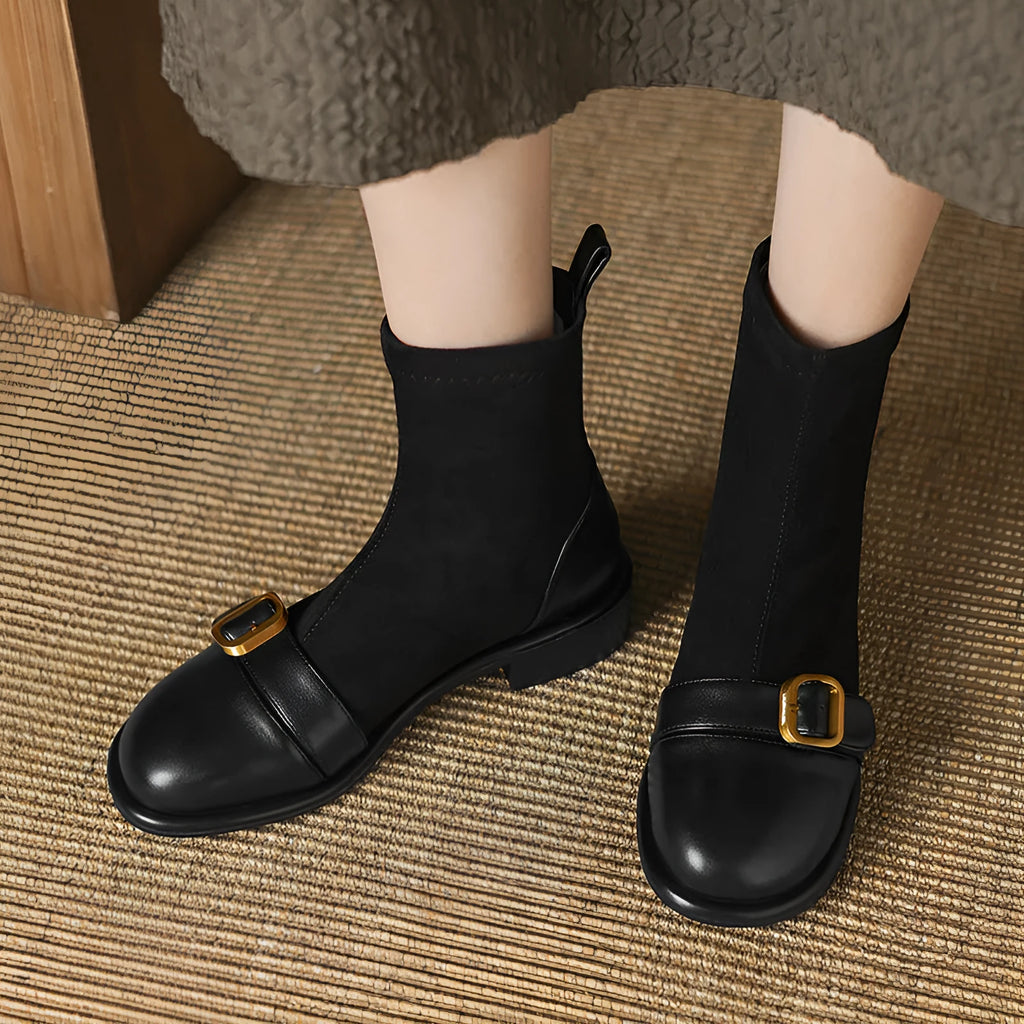 Women's black casual Martin-style ankle boots with buckle stitching and front lace-up on a low rubber sole.