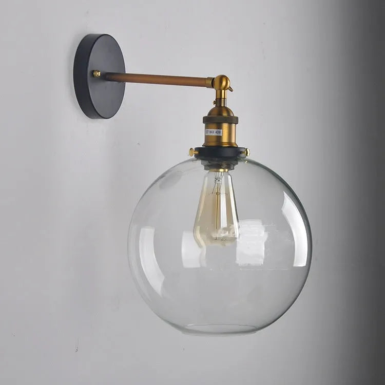 20cm round retro glass wall lamp in amber colour with aluminium holder on a white wall.