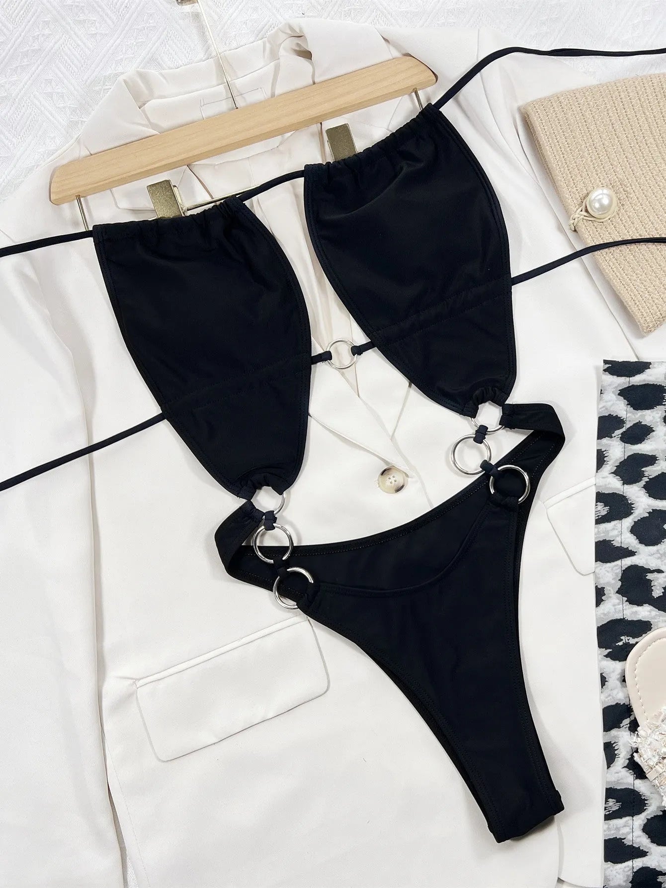 Black sleeveless one-piece swimming suit on a mannequin, front view.