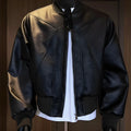 Men's black PU leather jacket with extended length and slim fit design shown from front