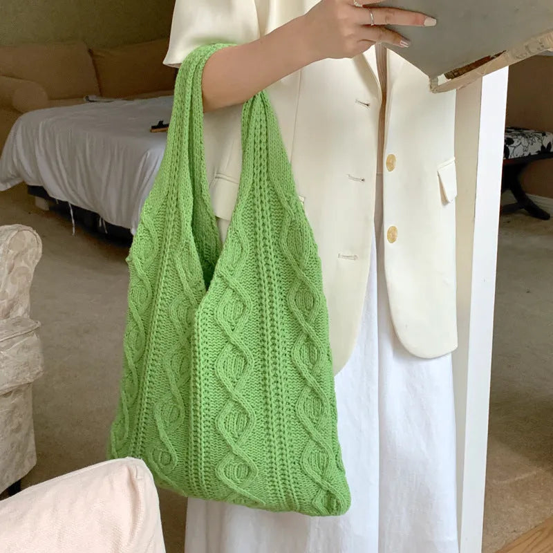 Women's retro-style knitted crochet tote bag with double shoulder straps in a solid colour.