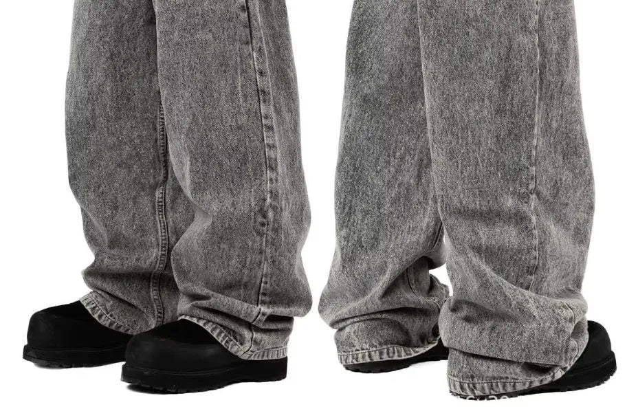 Grey loose straight-leg denim trousers for men and women on a hanger