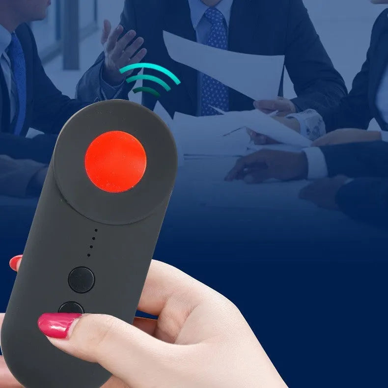 Black portable GPS and WiFi signal detector with laser scanner for hidden cameras on a table.