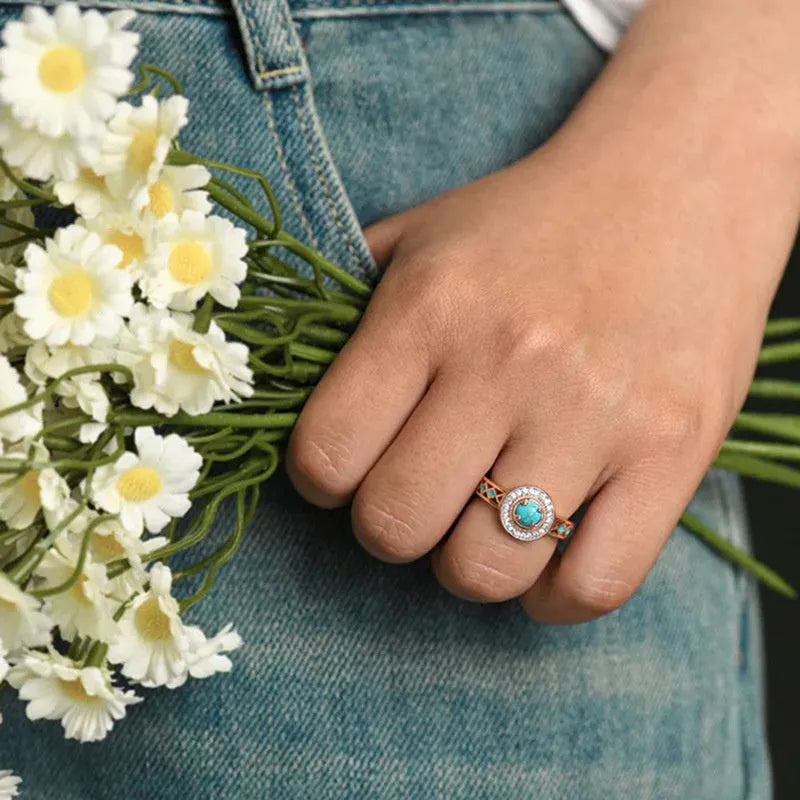 Women's rose gold coloured copper ring with geometric ethnic design and inlaid zircon detailing.