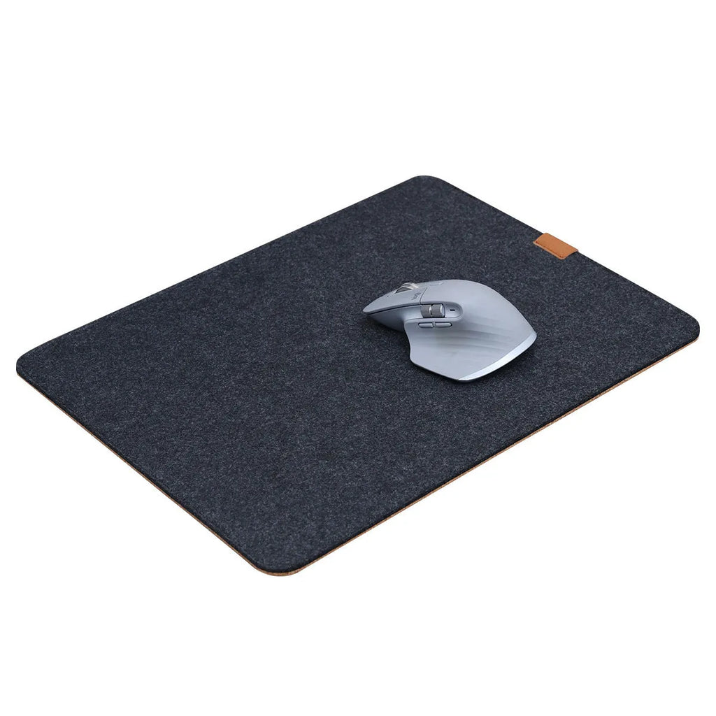 Oversized felt cork desk mouse mat in black and grey pattern, shown on a wooden desk.