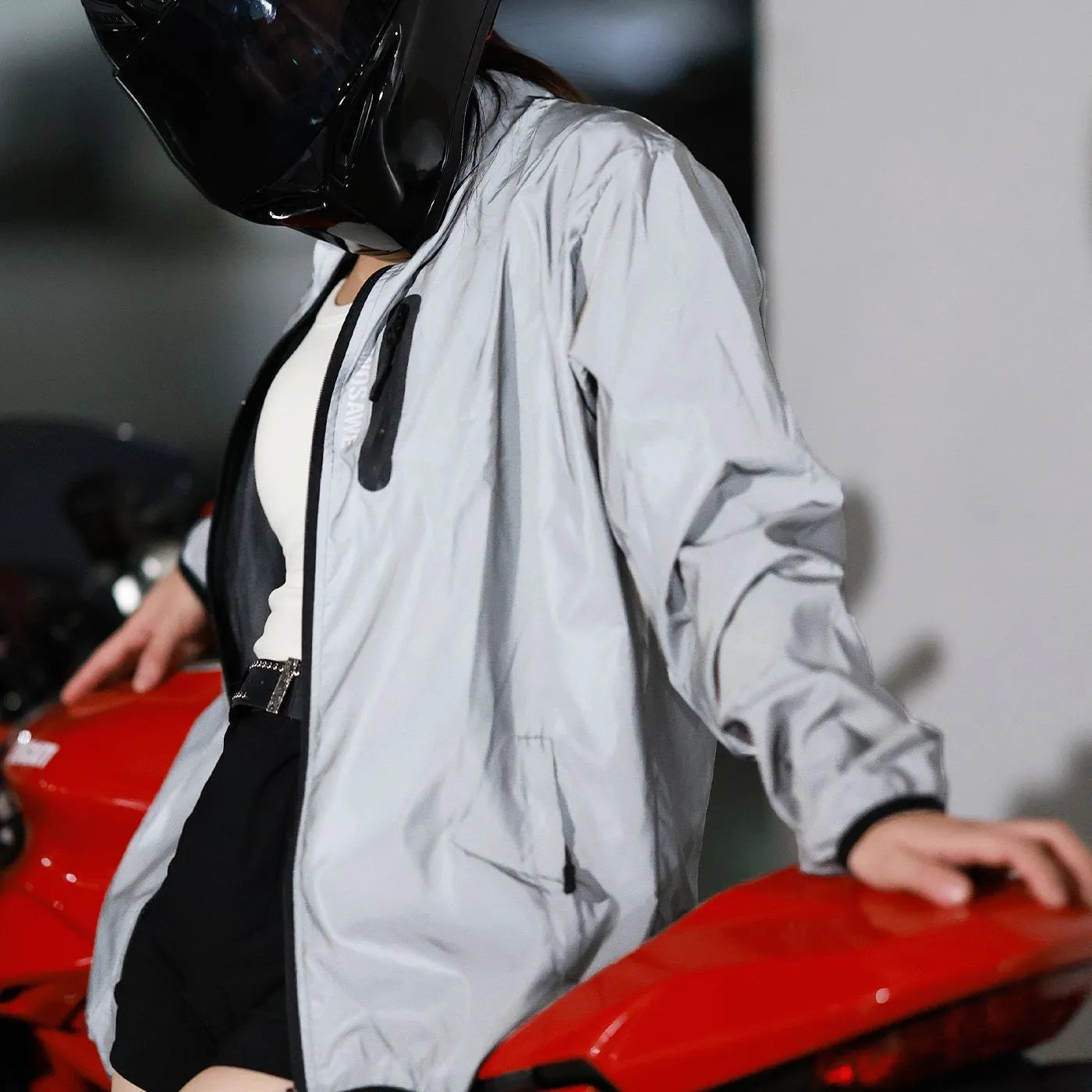 Silver coloured waterproof polyester long sleeve jacket for men on a hanger.