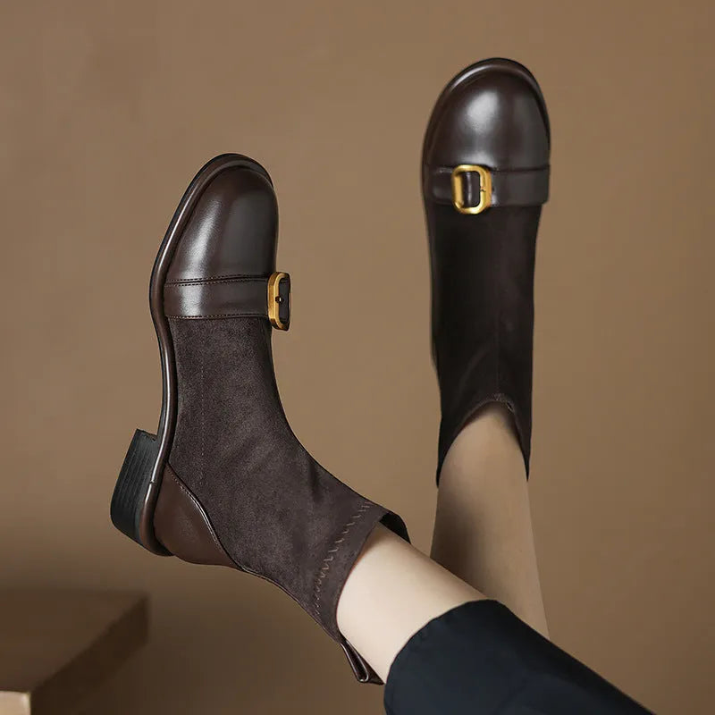 Women's black casual Martin-style ankle boots with buckle stitching and front lace-up on a low rubber sole.
