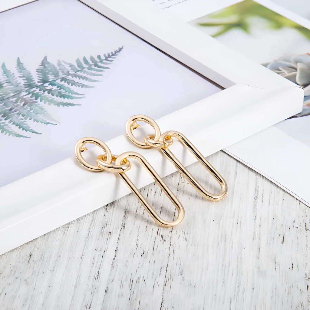 Sterling silver geometric hoop earrings with ring and line design on silver background