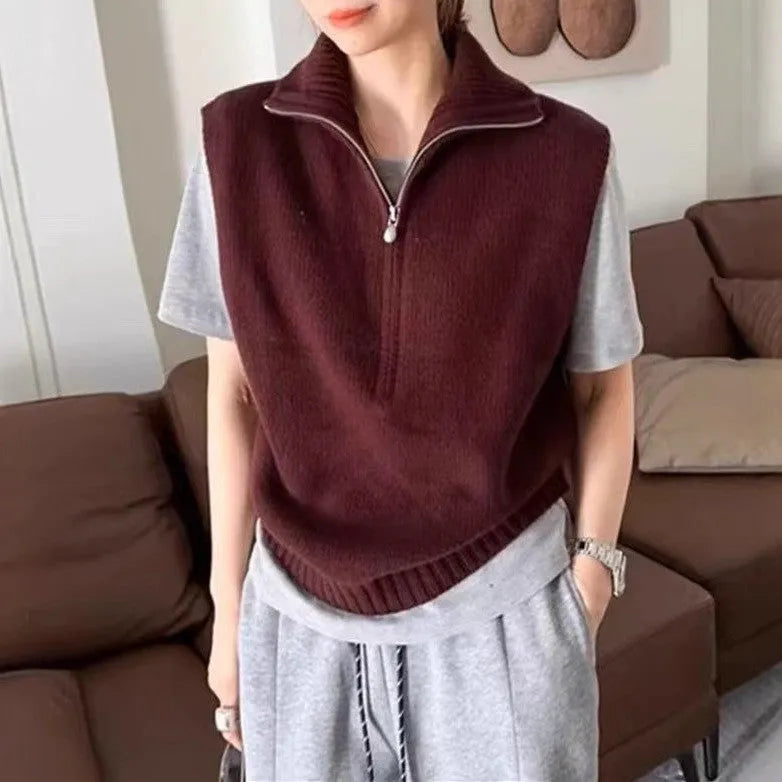 Orange sleeveless half-zip mesh knit vest on a hanger, casual style.
