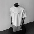 Men's short sleeve cotton t-shirt in loose pullover style showing white, black and light grey colour options