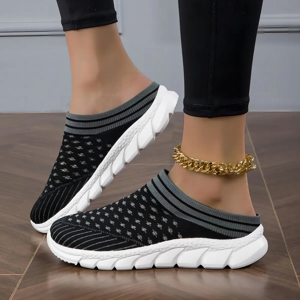 Women's black Flyknit socks semi slipper shoes with striped pattern and hollow-out design on a viscose sole.