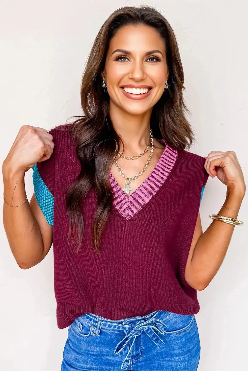 Burgundy loose V-neck sweater with contrast trim and short cuffed sleeves laid flat.