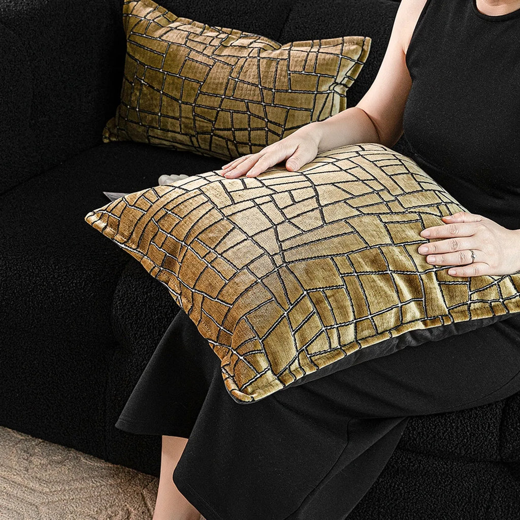 Local gold geometric abstract pattern on a square polyester cushion cover.