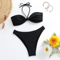 Black women's bikini set with lace-up tube top and briefs on a neutral background.