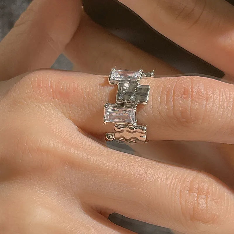 Silver geometric cross zircon ring with open gemstone design and three-dimensional decoration