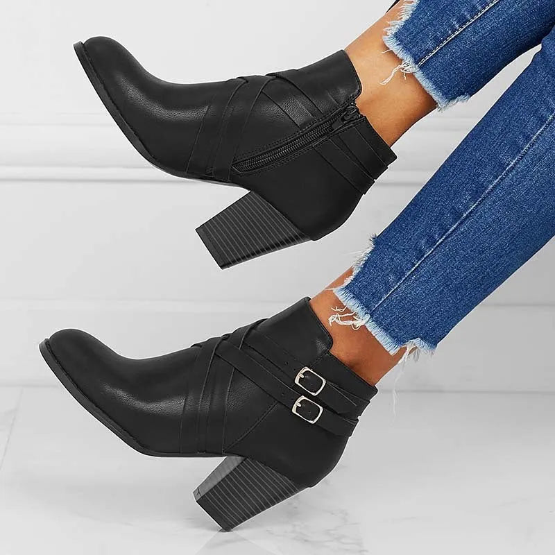 Grey plus-size short boot with 7cm heel, side zip, and buckle detail on a wooden floor