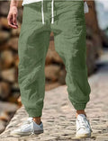Man wearing straight-leg cotton trousers with an elastic waistband in army green.