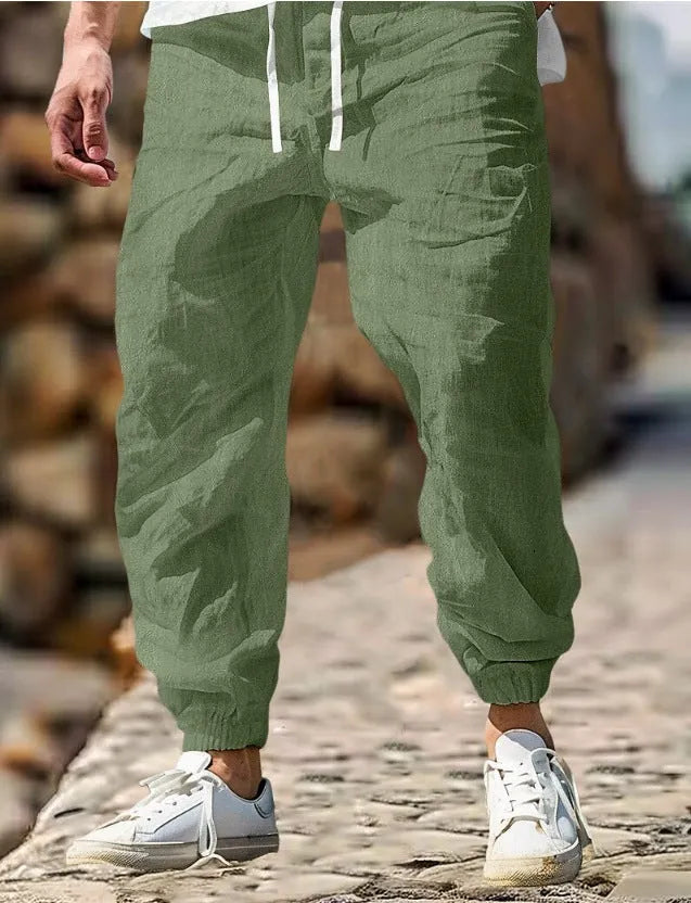 Man wearing straight-leg cotton trousers with an elastic waistband in army green.