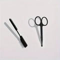 Black ambidextrous pet grooming brush with soft bristles and a fine-tooth comb for dogs and cats.