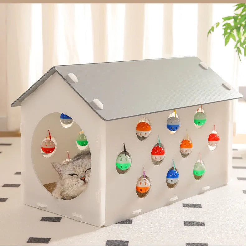 Plastic house cat scratch board with integrated tunnel containing a bell ball toy