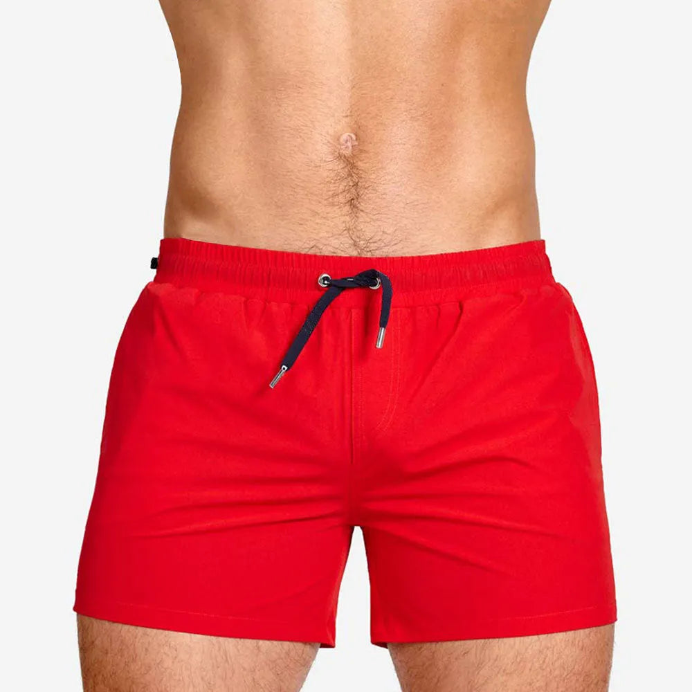 Mesh-lined sports shorts in polyester fabric with elastic waistband available in multiple colours