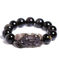 Polished crystal Pi Xiu bracelet with Ice Stone design on a wrist, showing geometric ethnic style.