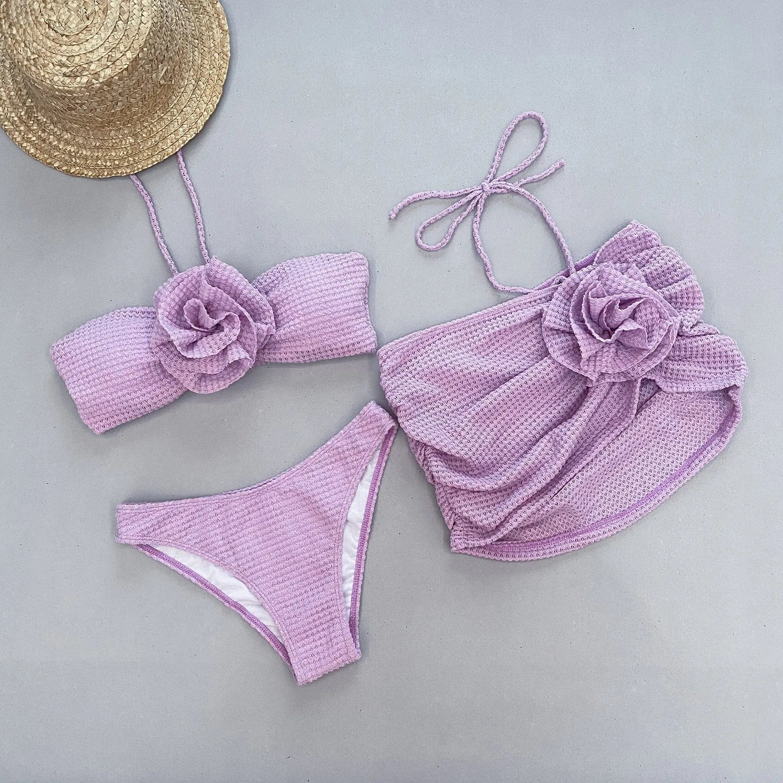 Women's purple and white 3D flower split three-piece bikini set with bra, panties, and skirt.