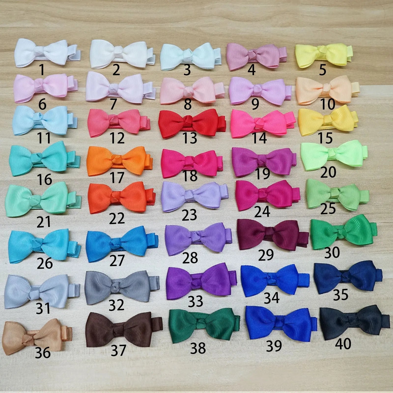 Assortment of pastel coloured baby hair clips and bows with no-slip lining.