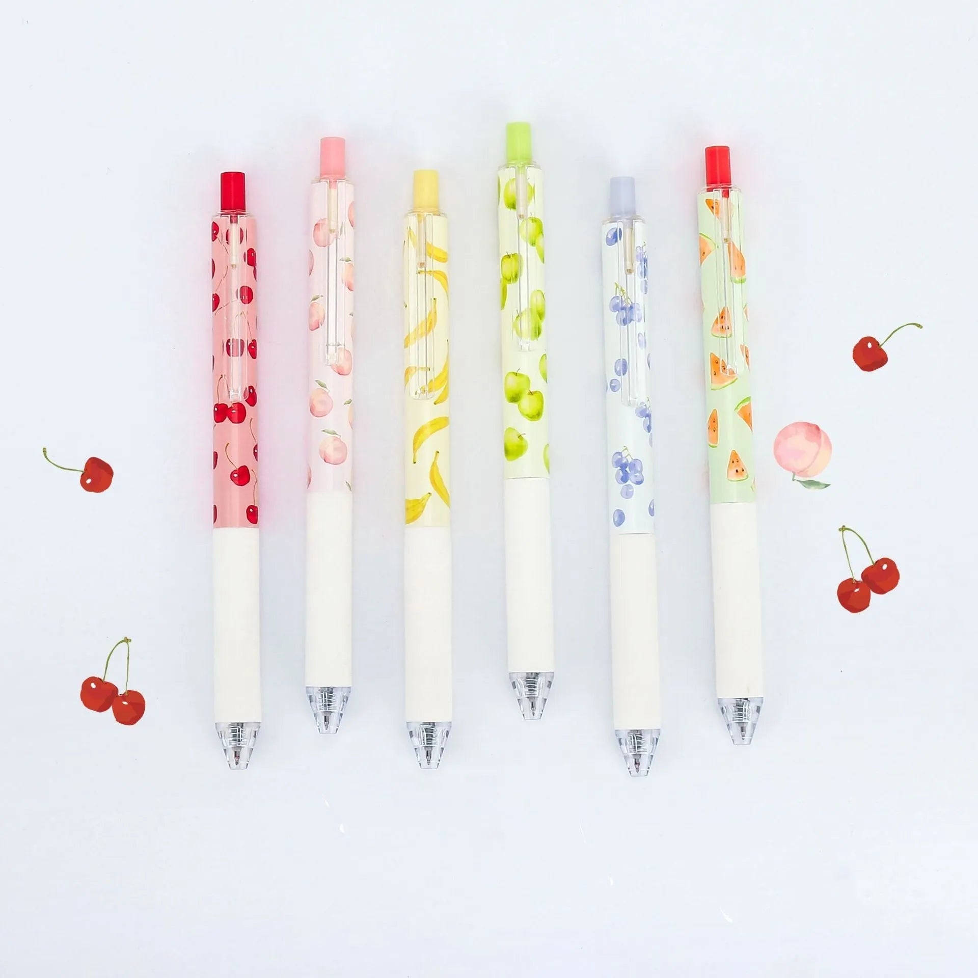 Three fruit-scented gel ink pens with 0.5mm black refills and press-action click mechanism