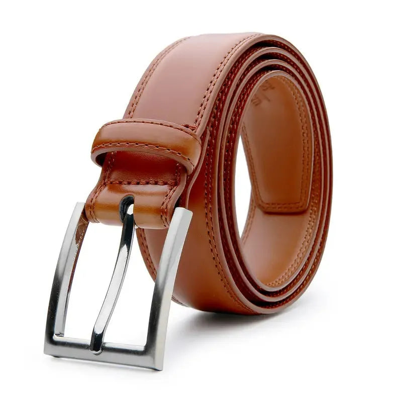 Men's brown leather belt with textured grain and metal buckle on a table.