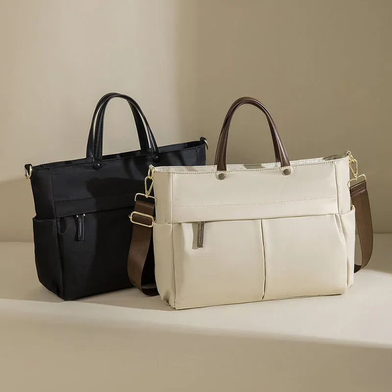 Women's Oxford cloth briefcase with shoulder strap showing open pocket organisation and contrast stitching details