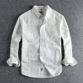 Men's light blue cotton long sleeve cardigan-style shirt on a hanger.