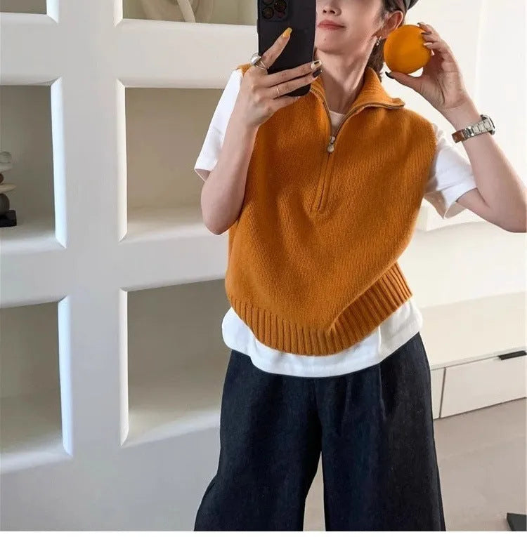 Orange sleeveless half-zip mesh knit vest on a hanger, casual style.