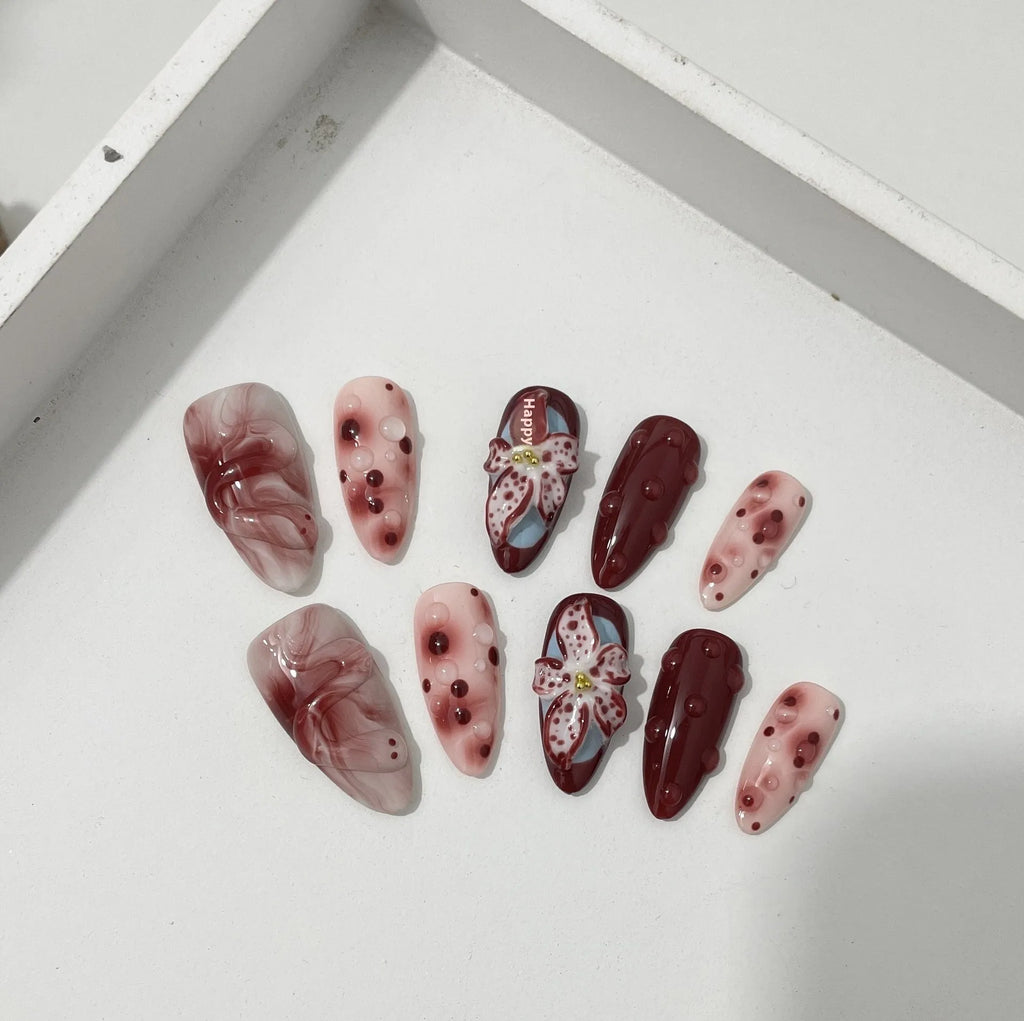 Hand-painted three-dimensional carved press-on nails with almond shape showing rose and tulip floral designs
