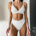 Women's grey bikini set with decorative embroidery and white contrast colour binding on the sleeveless top and shorts.